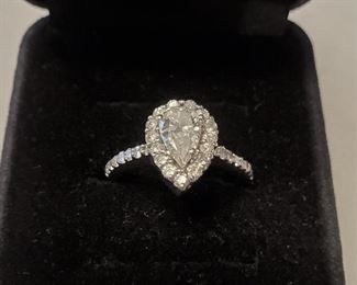 Ring with .90 carat halo set pear shaped diamond and 29 smaller diamonds set in 10 carat white gold. Full secondary market appraisal report performed by a gemologist will be provided to the buyer. 