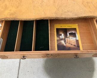 Buffet drawer with felt lined silverware dividers.