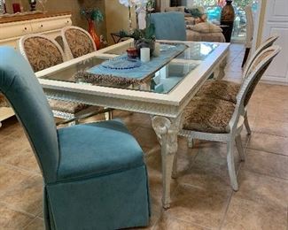 $1600-White carved wooden table with ram motif on legs with glass top with leaf and six custom upholstered chairs 