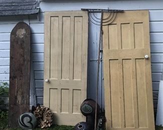 Old doors with porcelain knobs. Wooden antique rake. Art vases. Barnwood galore inside.