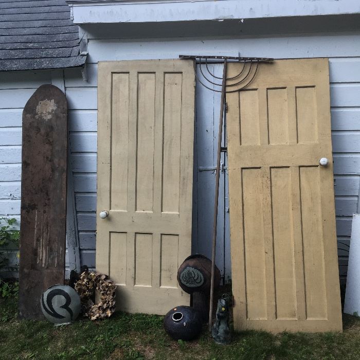 Old doors with porcelain knobs. Wooden antique rake. Art vases. Barnwood galore inside.