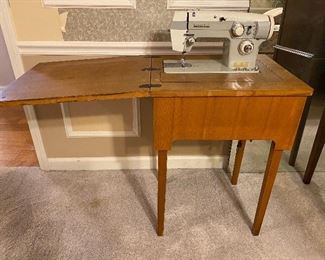 White sewing machine in cabinet 