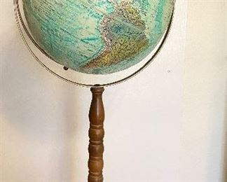 intage "Replogle" World Ocean Series globe on stand. 12" diameter raised relief globe. Metal base and walnut wooden spindle stand. Measures 32" tall. One spot shows wear area. $35
