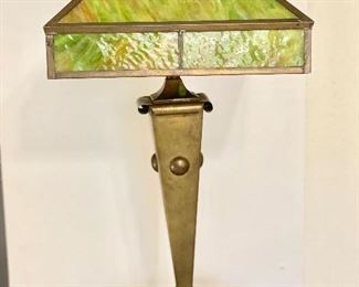 Vintage slag glass and brass lamp. New cord. Lamp measures 70" tall. The pictures show all sides of the glass panels. Shade is 14" wide and 9" tall. Original brass finial. One panel has a crack in it. A second panel has a hairline at the bottom corner and is hard to detect. No dents or damage to brass base. There are two imperfections on the lamp brass base. Very pretty and unique when lighted. $100