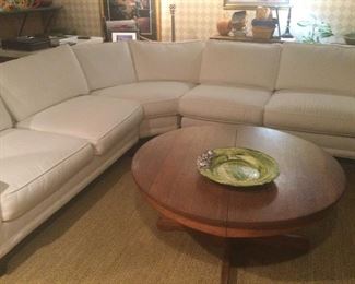Beautiful white Rowe sectional with round oak coffee table 