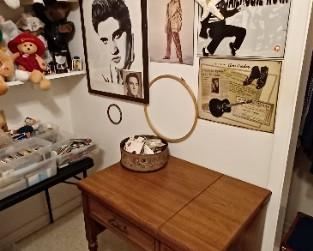 Elvis collectibles and sewing machine in cabinet