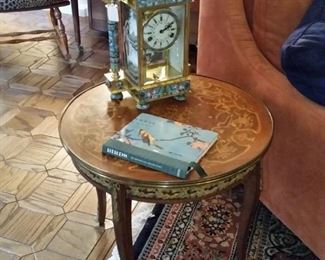 Beautiful Chinese clock on vintage table with inlaid designs