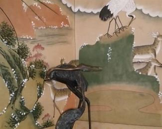 Mother and baby bronze herons