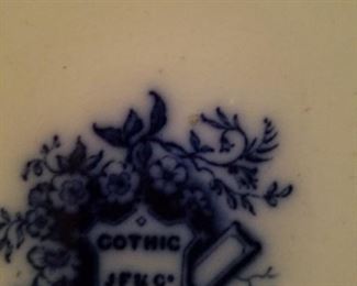 The logo on the back of the flow blue plate