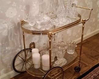 Brass serving cart with assortment of crystal