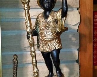 One of a vintage pair of gold gilt and black on bronze blackamoor candle holders