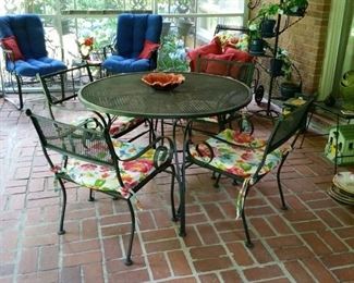 Wrought iron patio table with 4 chairs.  [All  cushions sold separately]