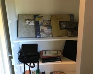 Bedroom #3/Office: An overview of items in the closet includes photo albums, music and sticker  books, and portable DVD player with two screens for your auto.