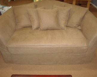 Lower Level: This is the smaller of the two RESTORATION HARDWARE sofas, measuring only 6 feet wide. This sofa also has a tight-back style with two detached seat cushions and 5 toss pillows as well as a light brown slipcover.  (A white sofa is underneath.)
