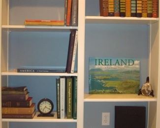 Family Room:  This bookcase has several books and a vintage-style clock as well as carved/painted duck decoys by Indiana artist "R. J. Hill."