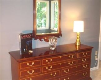 MASTER BEDROOM: This beautiful COUNCILL CRAFTSMAN ten drawer dresser measures 66 inches wide x 20 inches deep x 34 inches high.  It is priced separately from the Chippendale-style mirror that measures  28-1/2 inches wide x 51-1/2 inches tall.  The book, large "Metro" WATERFORD crystal vase (with original box), and gold lamp are also pried.  