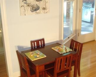 Kitchen: Don’t forget the kids and grandkids! This set of table and four chairs features a cubby under-shelf. The "Melissa & Doug" puzzles are just two of many available [downstairs in the theater room].  The grey floral canvas art is also priced!
