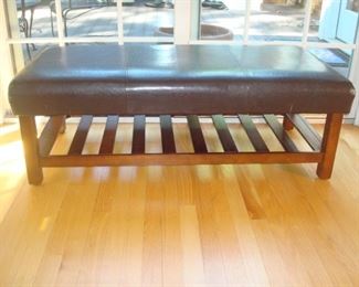 Family Room: Finish off your room with this brown cocktail ottoman which features a slat wood under shelf.