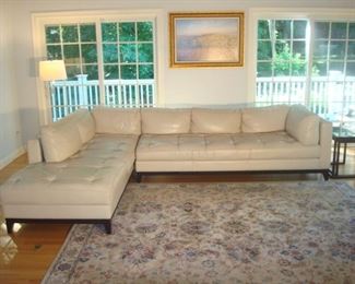 Family Room: Welcome home! Imagine this two-piece “ELITE” leather sectional in your home! Plenty of seating for all your guests. Each section is 92 inches long x 38 inches wide and has seven detached back cushions in total.  This sectional can be configured as shown or facing each other.  The silver floor lamp, art,  metal/glass nesting tables, and rug (shown in upcoming photo) are also available.