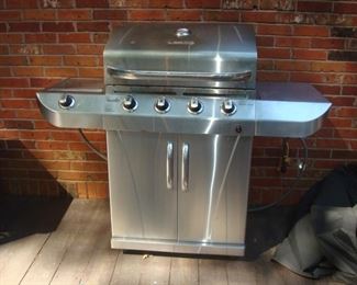 Deck: This CHAR-BROIL GAS GRILL is stainless and comes with a cover.