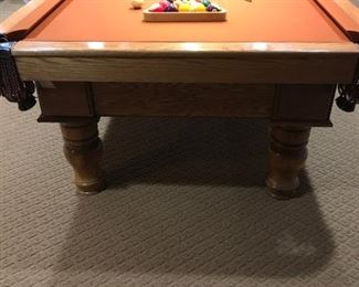 Lower Level:  This A. E. Schmidt pool table is in great condition!  The three-piece slate table has an oak finish case and leather pockets.   It measures 8' 2" x 4' 5".   Included in the price are the pool balls, ball racks, cue sticks, stand, and table cover.  More photos follow.