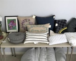 Bedroom #1:  Toss pillows  and shams are on top of the table while bed pillows are below.