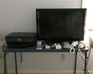 Bedroom 2: Don’t overlook this VIZIO 32" TV and remote or the HP EASY PHOTO 7155, as well as ink cartridges and Trimline telephones.