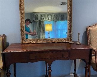 Antique solid wood buffet table with loads of detail.  Framed gilded mirror