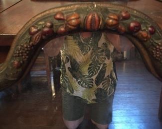elaborate detail on frame, hand carved wood. This is decoration on mirror's top .  FULL photo of mirror doesn't show this detail.. It's a beautiful addition to your home and a conversation piece as the detail "pops" out