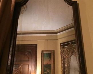 elaborate detail on frame, hand carved wood (see other photo of detail on top as tis one lighting not good).  It's a beautiful addition to your home and a conversation piece as the detail  makes it "pop" out