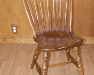 Round to oval table with 4 spindle back chairs.
