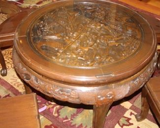 Asian themed carved coffee table with stools.