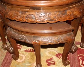 Asian themed carved coffee table with stools.
