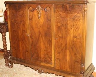 Tall silver and table linen cabinet.