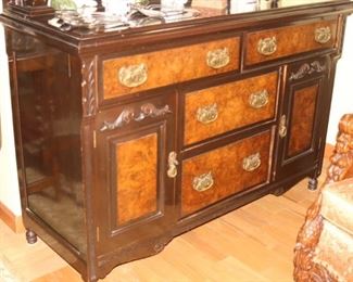 Yet another sideboard/bar with drawers, shelves and mirror.