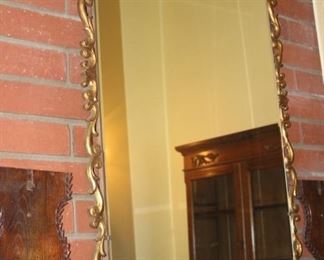 Very large gold framed mirror.