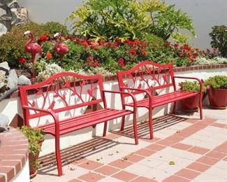 Two red metal garden seats.