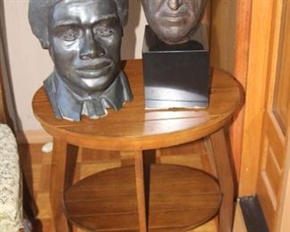 Two busts. Oval end table.