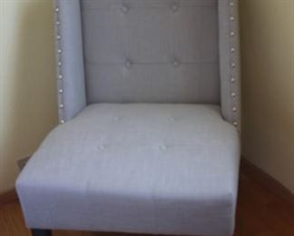 Grey fabric bedroom chair with hobnails.