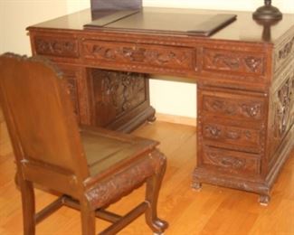 Carved Asian knee hole writing desk and chair.