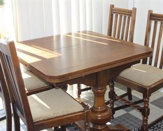 Kitchen table with pullout leaves and four chairs.