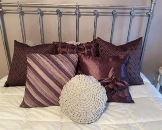 $45 - Set of 5 square purple throw pillows and 1 round light gray pillow 