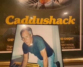 Photo of Chevy Chase autographing Caddyshack poster 