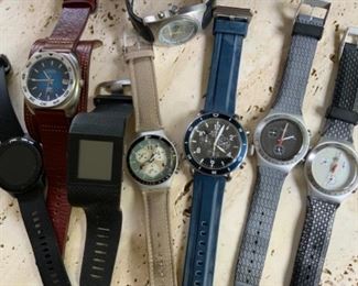 assorted watches, Shinola, swatch, Garmin