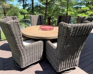 Arhaus outdoor round table with 6 chairs that swivel and rock (table measures 62" diameter)