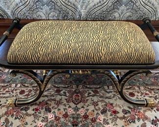 Animal print bench with iron legs and bars.
