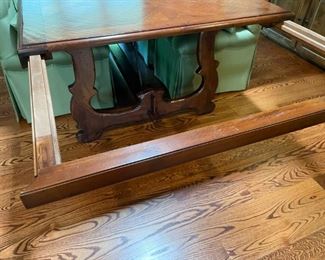 Extensions pull out from underneath and leaf added on top.