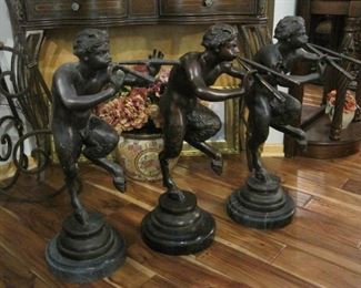 Three large flute playing Bronze Fauns.