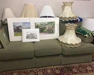 J. Rayomond Sofa with various water color prints and lamp shades and afghans