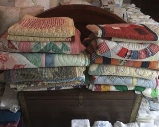 assortment of quilts on old chest